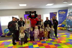 The children from Sunshine Nursery meeting Sampson the mascot from the Foundation of Light.