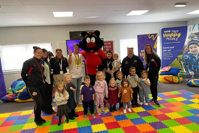 The children from Sunshine Nursery meeting Sampson the mascot from the Foundation of Light.