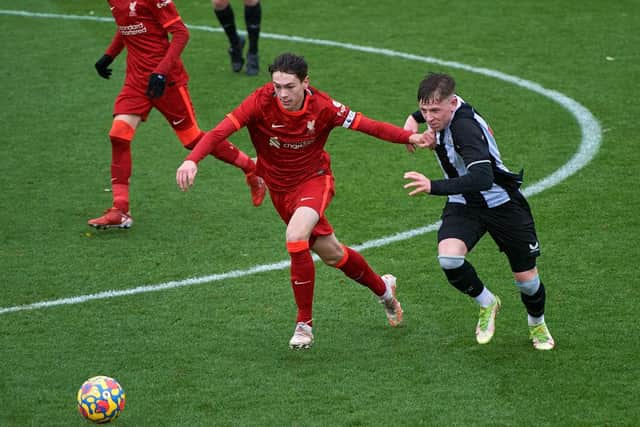 Luke Chambers of Liverpool and Jay Turner-Cooke of Newcastle United in action.
