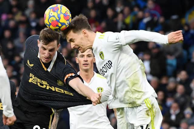Newcastle United's Chris Wood vies with Leeds United's Diego Llorente.
