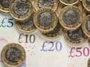 What is the National Living Wage and what is the minimum hourly rate of pay currently in the UK in 2022?