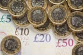 What is the National Living Wage and what is the minimum hourly rate of pay currently in the UK in 2022?