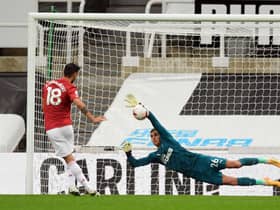Karl Darlow stops a penalty from Bruno Fernandes.