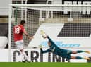 Karl Darlow stops a penalty from Bruno Fernandes.