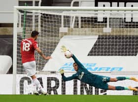 Karl Darlow stops a penalty from Bruno Fernandes.