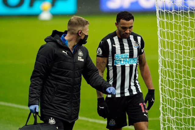 Callum Wilson of Newcastle United leaves the pitch with medical staff as he is substituted off due to injury during the Premier League match between Newcastle United and Southampton at St. James Park on February 06, 2021 in Newcastle upon Tyne, England.