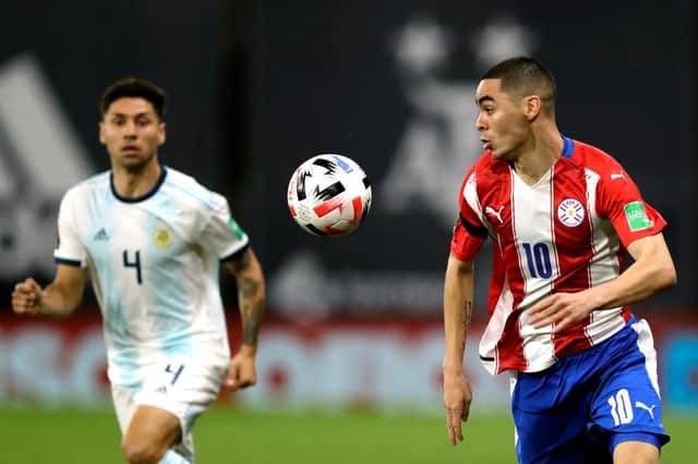 BUENOS AIRES, ARGENTINA - NOVEMBER 12: Miguel Almirón of Paraguay controls the ball against Gonzalo Montiel of Argentina during a match between Argentina and Paraguay as part of South American Qualifiers for Qatar 2022 at Estadio Alberto J. Armando on November 12, 2020 in Buenos Aires, Argentina. (Photo by Juan I. Roncoroni-Pool/Getty Images)