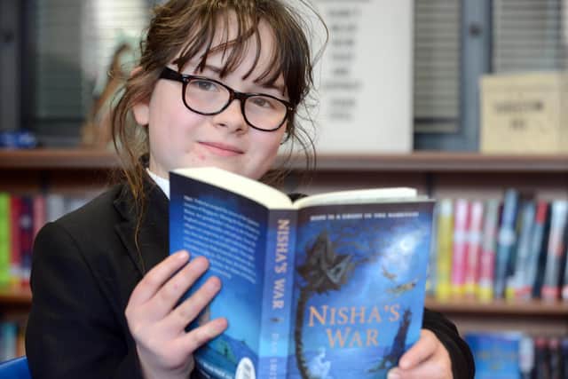 Year 7 pupil, Bethany Gilligan, 12, enjoying one of Dan's books.