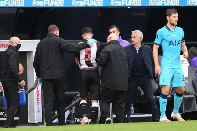 NEWCASTLE UPON TYNE, ENGLAND - JULY 15: Fabian Schar of Newcastle United leaves the pitch with an injury during the Premier League match between Newcastle United and Tottenham Hotspur at St. James Park on July 15, 2020 in Newcastle upon Tyne, England.