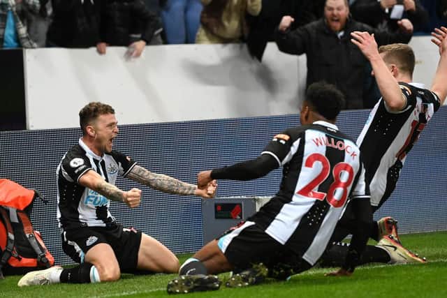 Newcastle player Kieran Trippier celebrates with team mates after scoring the third goal from a free kick during the Premier League match between Newcastle United and Everton at St. James Park on February 08, 2022 in Newcastle upon Tyne, England. (Photo by Stu Forster/Getty Images)