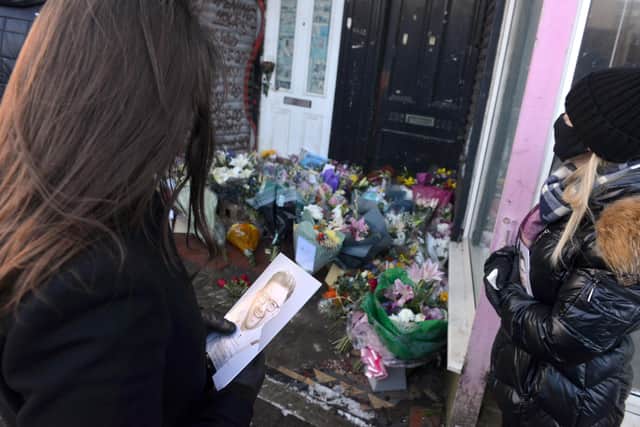 Tributes were left outside Stoney's Barber Shop.