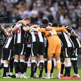 Newcastle players form a group huddle on the pitch ahead of the English Premier League football match between Newcastle United and Tottenham Hotspur at St James' Park in Newcastle-upon-Tyne, north east England on October 17, 2021. - R(Photo by PAUL ELLIS/AFP via Getty Images)