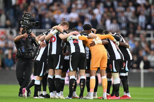 Newcastle players form a group huddle on the pitch ahead of the English Premier League football match between Newcastle United and Tottenham Hotspur at St James' Park in Newcastle-upon-Tyne, north east England on October 17, 2021. - R(Photo by PAUL ELLIS/AFP via Getty Images)