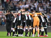 Newcastle players form a group huddle on the pitch ahead of the English Premier League football match between Newcastle United and Tottenham Hotspur at St James' Park in Newcastle-upon-Tyne, north east England on October 17, 2021. - R(Photo by PAUL ELLIS/AFP via Getty Images)