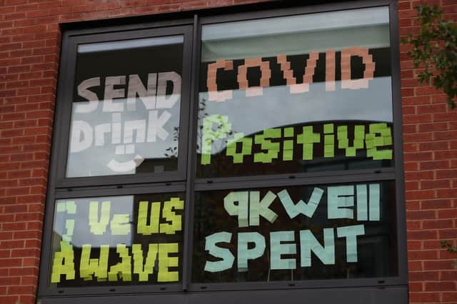 Signs on a window at Manchester Metropolitan University's Birley campus where hundreds of students have been told to self-isolate after 127 of them tested positive for coronavirus. Photo credit: Peter Byrne/PA Wire
