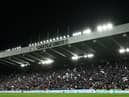 Newcastle United fans wave flags and scarves in the East Stand ahead of last night's Carabao Cup quarter-final against Leicester City.