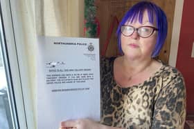 Diane Maines holding a sign she has placed inside a window of her Hebburn home. Picture by FRANK REID