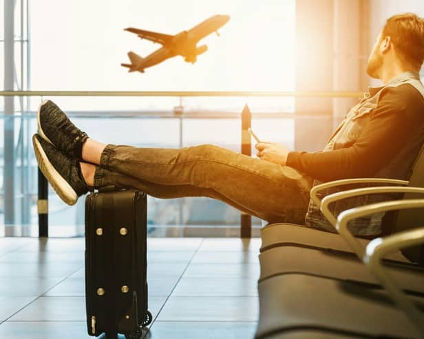 Passenger waits in the departure lounge of an airport