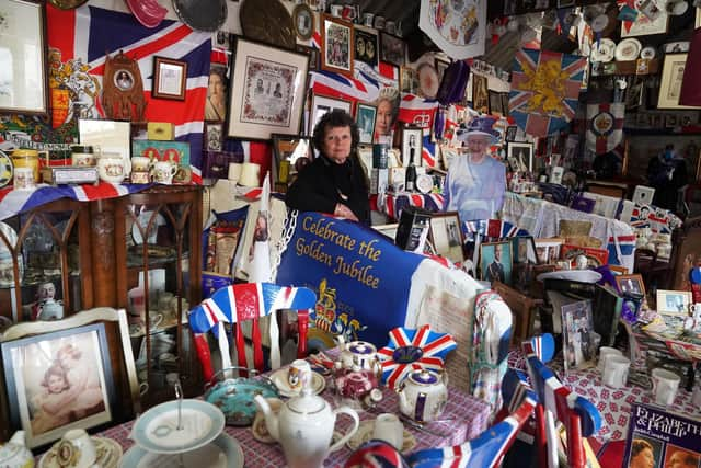 Anita Atkinson arranging the Queen and the Duke of Edinburgh's section of her royal memorabilia collection. Picture: Owen Humphreys/PA Wire.