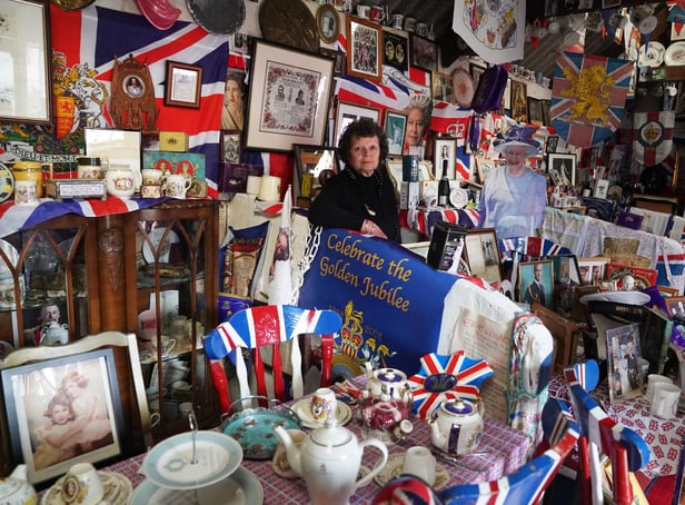 Anita Atkinson arranging the Queen and the Duke of Edinburgh's section of her royal memorabilia collection. Picture: Owen Humphreys/PA Wire.