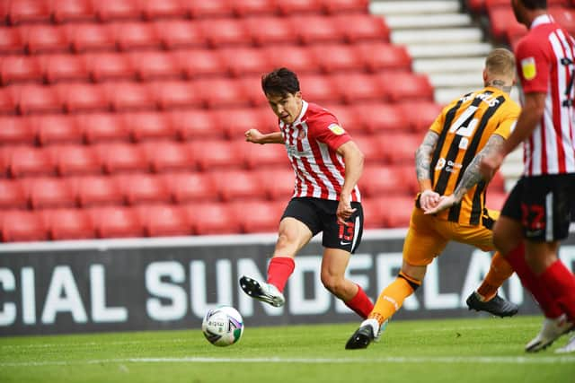 Luke O'Nien crosses for Will Grigg, who was ruled offside after scoring