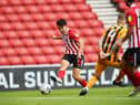 Luke O'Nien crosses for Will Grigg, who was ruled offside after scoring