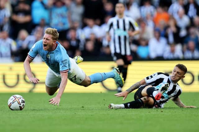 Kevin De Bruyne of Manchester City is fouled by Kieran Trippier of Newcastle United, leading to a red card which is later overturned by VAR during the Premier League match between Newcastle United and Manchester City at St. James Park on August 21, 2022 in Newcastle upon Tyne, England. (Photo by Clive Brunskill/Getty Images)