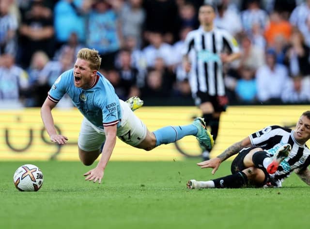 Kevin De Bruyne of Manchester City is fouled by Kieran Trippier of Newcastle United, leading to a red card which is later overturned by VAR during the Premier League match between Newcastle United and Manchester City at St. James Park on August 21, 2022 in Newcastle upon Tyne, England. (Photo by Clive Brunskill/Getty Images)