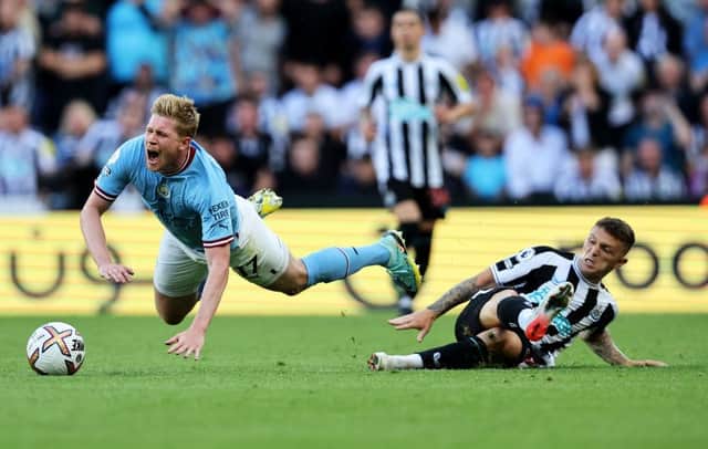 Kevin De Bruyne of Manchester City is fouled by Kieran Trippier of Newcastle United, leading to a red card which is later overturned by VAR during the Premier League match between Newcastle United and Manchester City at St. James Park on August 21, 2022 in Newcastle upon Tyne, England. (Photo by Clive Brunskill/Getty Images)