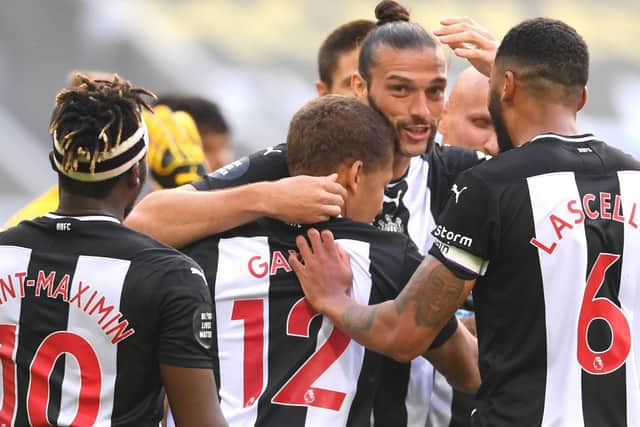 Dwight Gayle of Newcastle United celebrates with Andy Carroll and Jamaal Lascelles.