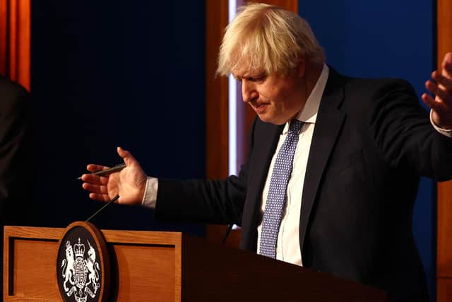 Prime Minister Boris Johnson gestures whilst speaking at a press conference in London's Downing Street after ministers met to consider imposing new restrictions in response to rising cases and the spread of the Omicron variant. Picture date: Wednesday December 8, 2021.