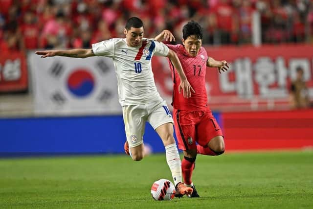 Paraguay's Miguel Almiron (L) fights for the ball with South Korea's Na Sang-ho (R) during a friendly football match between South Korea and Paraguay in Suwon on June 10, 2022. (Photo by Jung Yeon-je / AFP) (Photo by JUNG YEON-JE/AFP via Getty Images)