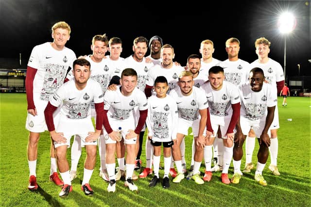 South Shields' players with Karl Thirlwall, who was mascot for Wednesday's game against Sunderland Under-23s - the players wore the shirts for the warm-up.