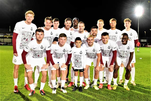 South Shields' players with Karl Thirlwall, who was mascot for Wednesday's game against Sunderland Under-23s - the players wore the shirts for the warm-up.
