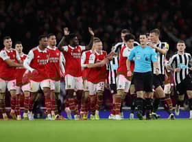Arsenal players surround the Referee Andy Madley after a late penalty appeal during the Premier League match between Arsenal FC and Newcastle United at Emirates Stadium on January 03, 2023 in London, England. (Photo by Julian Finney/Getty Images)