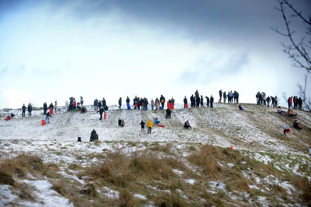 Crowds gather on snowy peak at Cleadon Hills