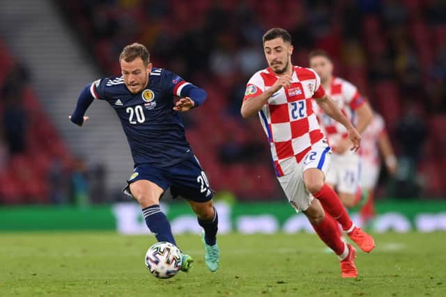 Ryan Fraser of Scotland runs with the ball as he is closed down by Josip Juranovic of Croatia during the UEFA Euro 2020 Championship Group D match between Croatia and Scotland at Hampden Park on June 22, 2021 in Glasgow, Scotland.