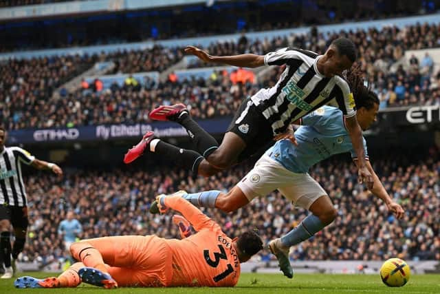 Manchester City's Brazilian goalkeeper Ederson saves at the feet of Newcastle United's Swedish striker Alexander Isak during the English Premier League football match between Manchester City and Newcastle United at the Etihad Stadium in Manchester, north west England, on March 4, 2023. (Photo by Paul ELLIS / AFP) / RESTRICTED TO