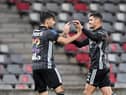 Lyon's Brazilian midfielder Bruno Guimaraes (R) celebrates after scoring a goal with Lyon's Brazilian midfielder Lucas Paqueta (L) during the French L1 football match between Nimes Olympique and Olympique Lyonnais at the Costieres Stadium in Nimes, southern France on May 16, 2021. (Photo by NICOLAS TUCAT/AFP via Getty Images)