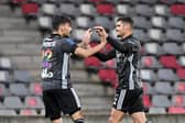Lyon's Brazilian midfielder Bruno Guimaraes (R) celebrates after scoring a goal with Lyon's Brazilian midfielder Lucas Paqueta (L) during the French L1 football match between Nimes Olympique and Olympique Lyonnais at the Costieres Stadium in Nimes, southern France on May 16, 2021. (Photo by NICOLAS TUCAT/AFP via Getty Images)