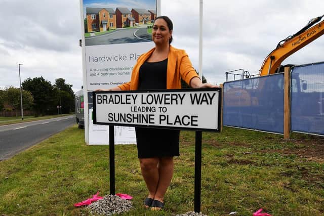 Gemma Lowery, pictured behind the Bradley Lowery Way street sign.