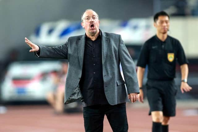 Dalian Yifang's new head coach Rafael Benitez (L) gestures during the Chinese Super League (CSL) football match between Dalian Yifang and Henan Jianye in Dalian in northeast China's Liaoning province on July 7, 2019. (Photo by STR / AFP) / China OUT        (Photo credit should read STR/AFP via Getty Images)