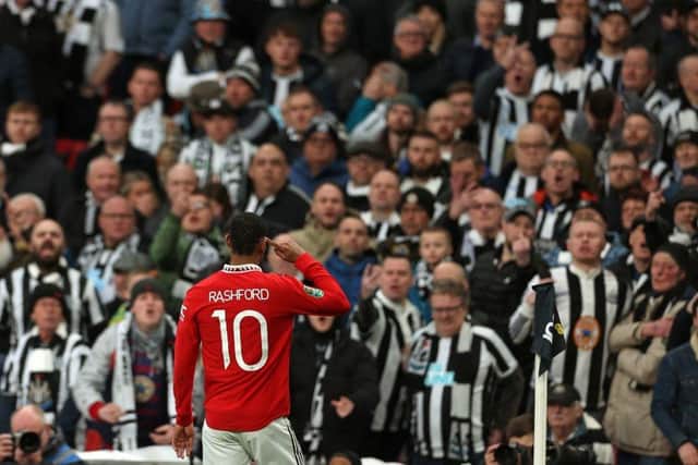 Manchester United striker Marcus Rashford celebrates his deflected goal in front of Newcastle United's fans.