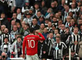 Manchester United striker Marcus Rashford celebrates his deflected goal in front of Newcastle United's fans.