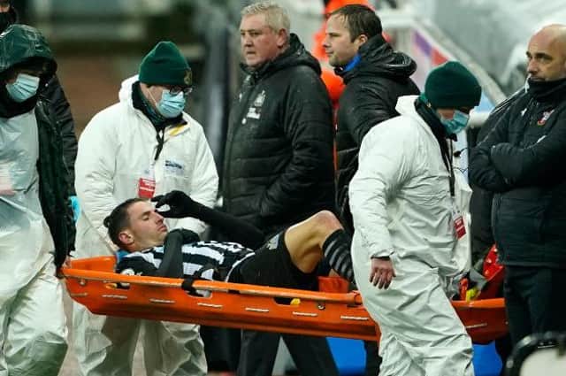 Fabian Schar of Newcastle United goes off injured on a stretcher during the Premier League match between Newcastle United and Southampton at St. James Park on February 06, 2021 (Photo by Owen Humphreys - Pool/Getty Images)