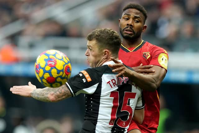 Kieran Trippier and Watford's Emmanuel Dennis battle for the ball.