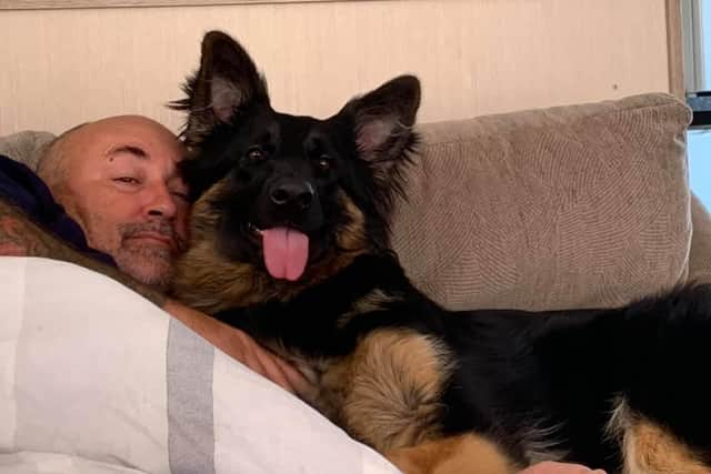 Phil with one of the couple's four dogs. Lisa describes them as her 'babies'.