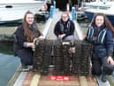 Members of the Stronger Shores team add oysters to one of the Wild Oyster project's North east farms