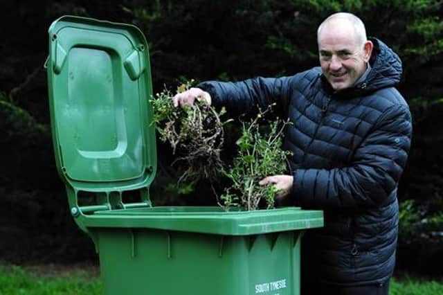Cllr Ernest Gibson with one of the garden waste bins
