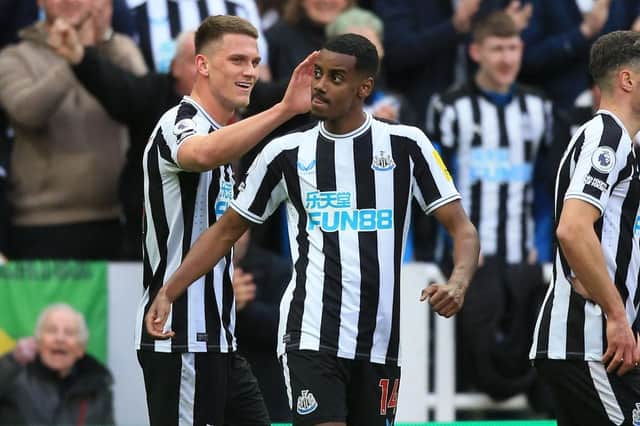 Newcastle United's Swedish striker Alexander Isak (C) celebrates after scoring the opening goal of the English Premier League football match between Newcastle United and Wolverhampton Wanderers at St James' Park in Newcastle-upon-Tyne, north-east England on March 12, 2023. (Photo by Lindsey Parnaby / AFP)